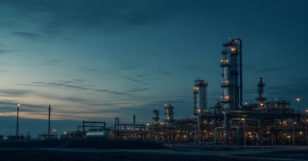Industrial oil and gas facility at dusk representing measurement-based methane reporting for OGMP 2.0